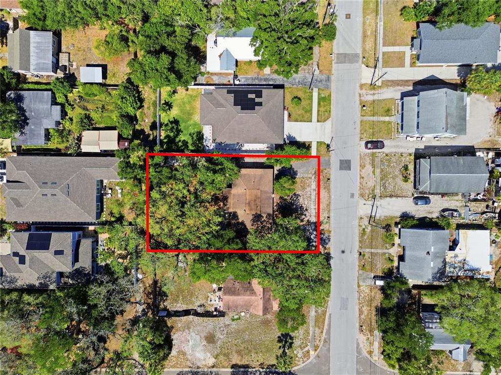 An aerial view shows a house with a red outline on a residential street — 831 GRAND CENTRAL STREET, CLEARWATER, FL