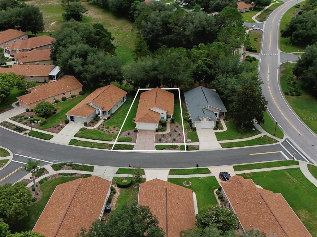 An aerial view shows a single-family home with a brown roof and paved driveway — 259 CENTER OAK CIRCLE, SPRING HILL, FL