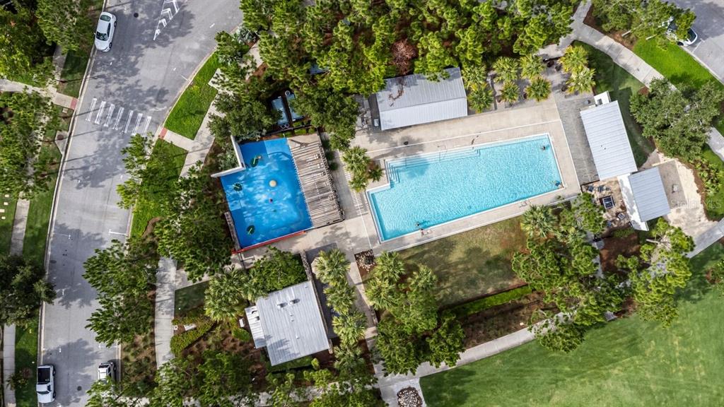 An aerial view shows a community swimming pool, a splash pad, and surrounding landscaped grounds — 13027 BATTEN LANE, ODESSA, FL