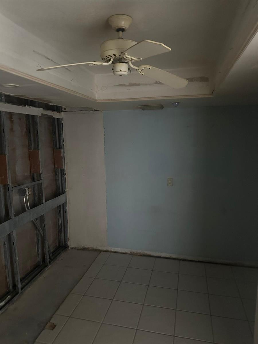 An unfinished room with a ceiling fan, tiled floor, and exposed metal wall framing — 2425 Presidential Way # 1203, West Palm Beach FL 33401, WEST PALM BEACH, FL