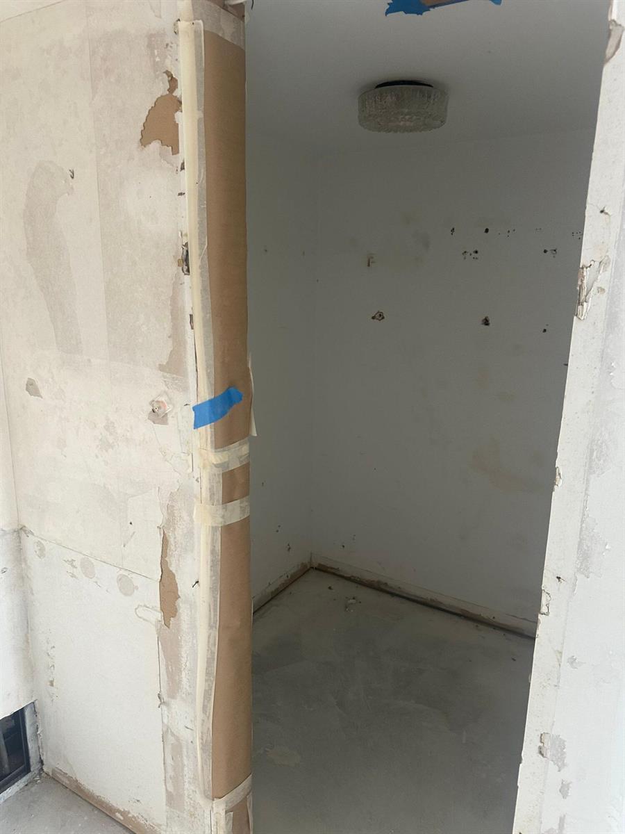 An unfinished small room with bare walls, a concrete floor, and a ceiling light fixture — 2425 Presidential Way # 1203, West Palm Beach FL 33401, WEST PALM BEACH, FL