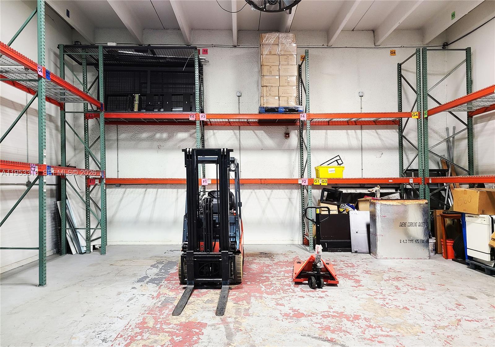A warehouse interior features industrial metal shelving units, a forklift, and a pallet jack — 7344 NW 56th St # 7344, Miami FL 33166, MIAMI, FL