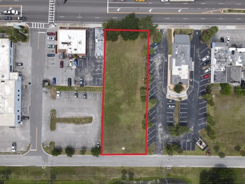 An aerial view shows a rectangular vacant lot outlined in red between two paved parking lots — 0 S 3rd Street, Fort Pierce FL 34950, FORT PIERCE, FL