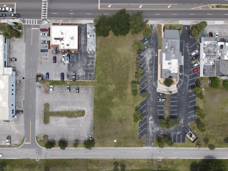 An aerial view shows a vacant rectangular lot situated between two commercial properties with parking lots — 0 S 3rd Street, Fort Pierce FL 34950, FORT PIERCE, FL