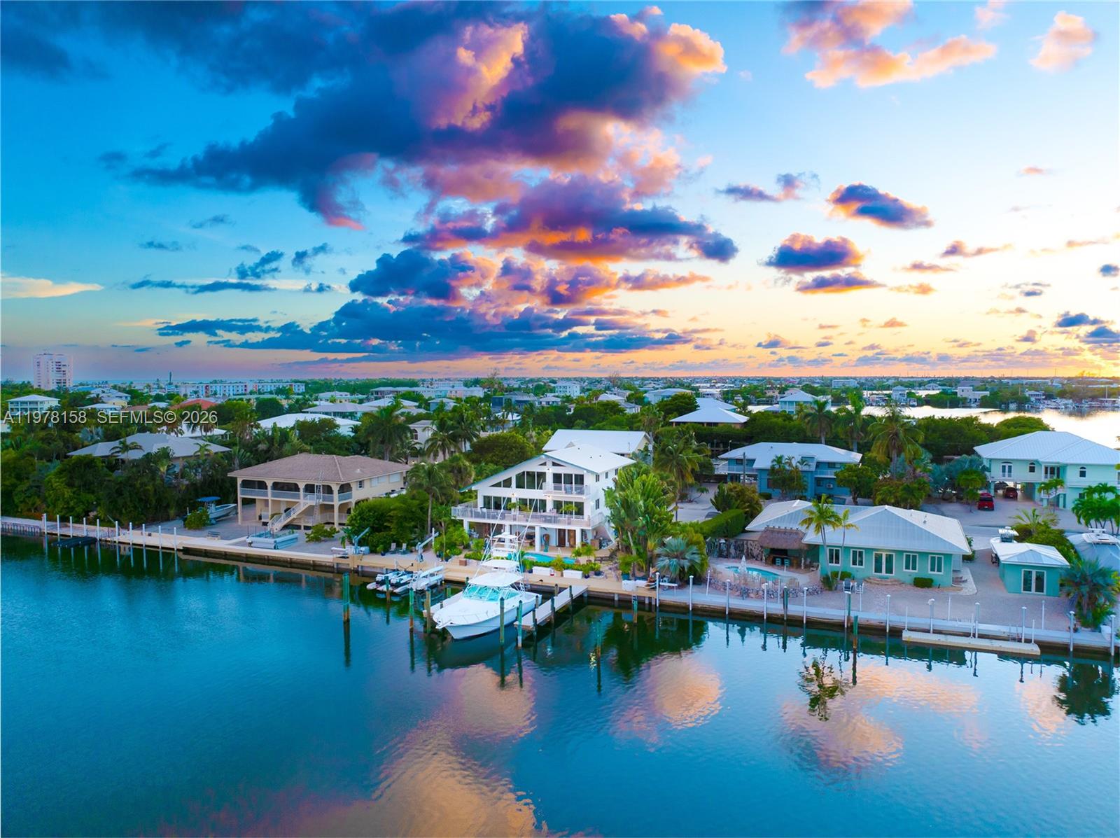 An aerial view shows a waterfront house with a boat docked at a private pier — 14 Avenue F, Marathon FL 33050, MARATHON, FL