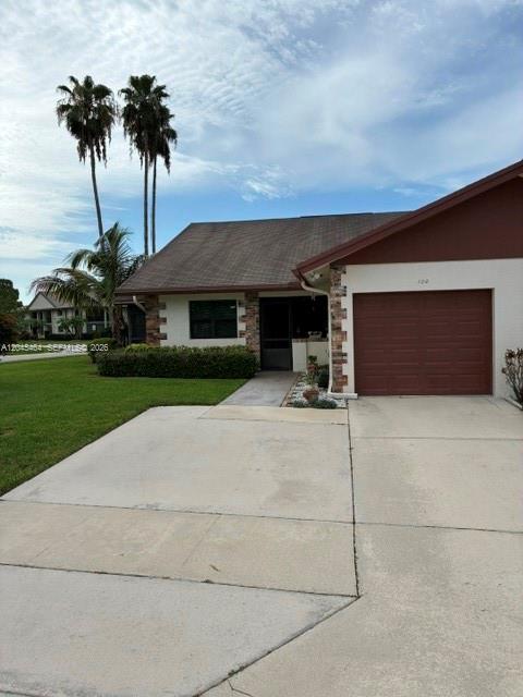 A single-story house with a screened porch, brown roof, and a large front lawn — 100 S Moccasin Trl S, Jupiter FL 33458, JUPITER, FL
