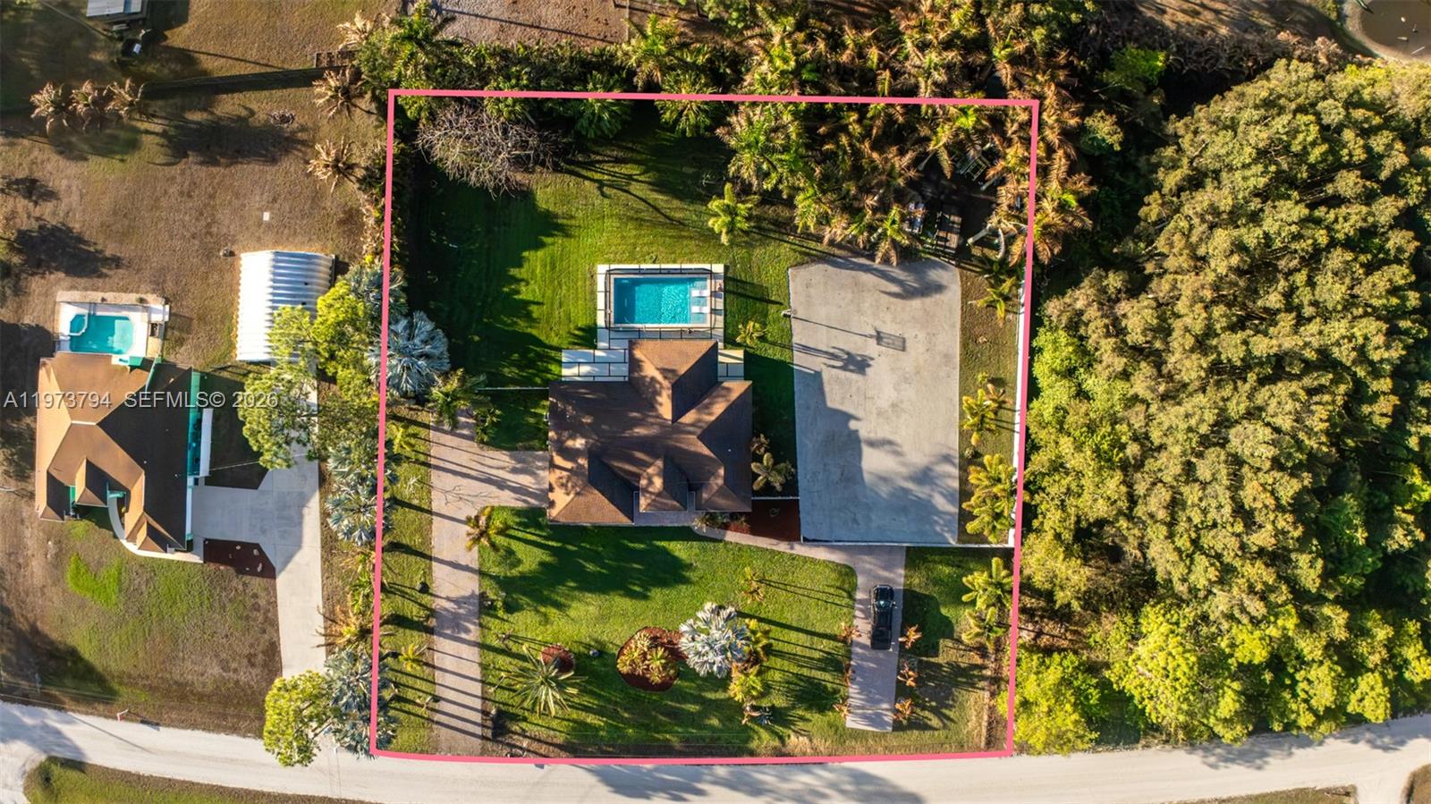 An aerial view shows a house with a pool and a large driveway on a lot — 15780 N 75th Ln N, Loxahatchee FL 33470, LOXAHATCHEE, FL