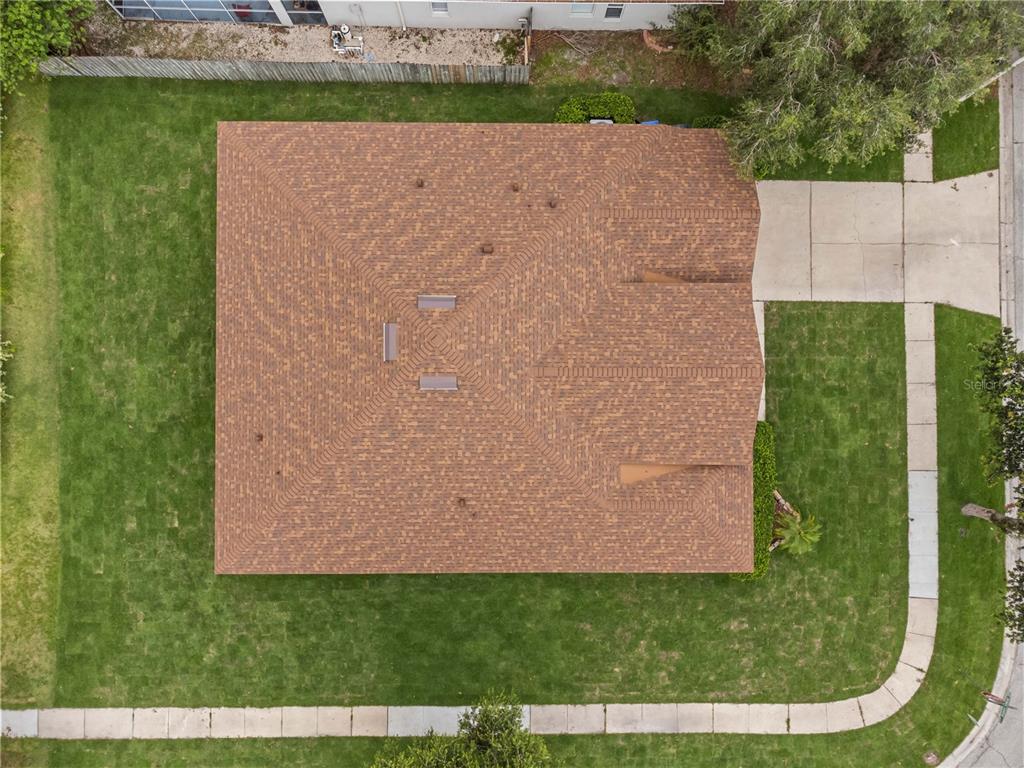 An aerial view shows the shingled roof of a house surrounded by a green lawn — 11611 JORDANS LANDING COURT, RIVERVIEW, FL