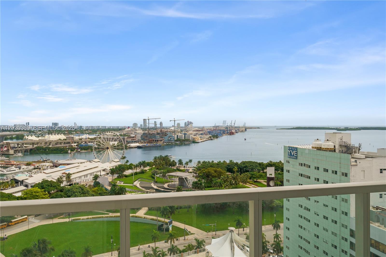 A high-angle view from a balcony overlooks a park, a Ferris wheel, and a harbor — 253 NE 2nd St # 2003, Miami FL 33132, MIAMI, FL