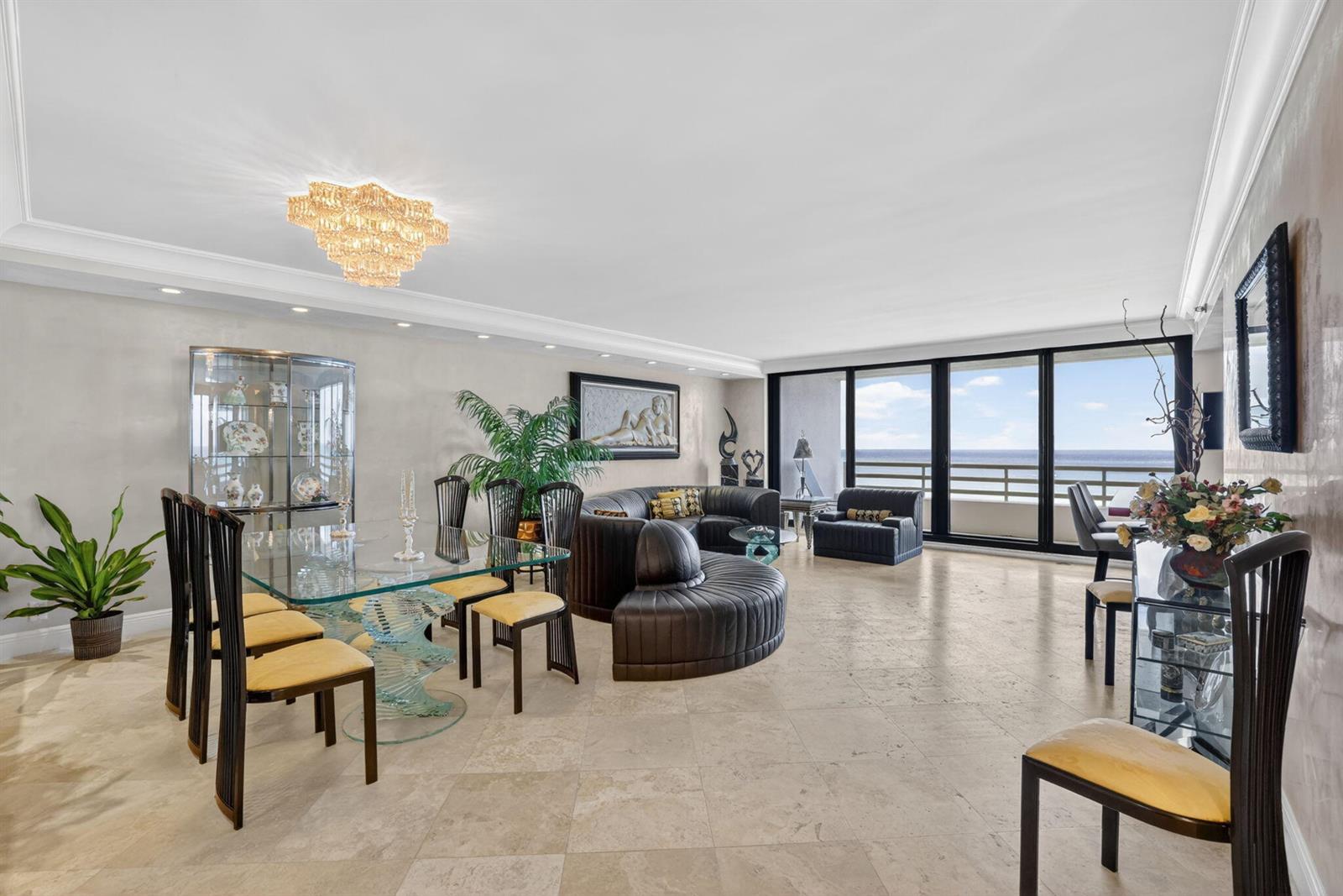 A spacious living and dining room features tile floors, a glass table, and ocean views — 1400 S Ocean Boulevard # 1003, Boca Raton FL 33432, BOCA RATON, FL