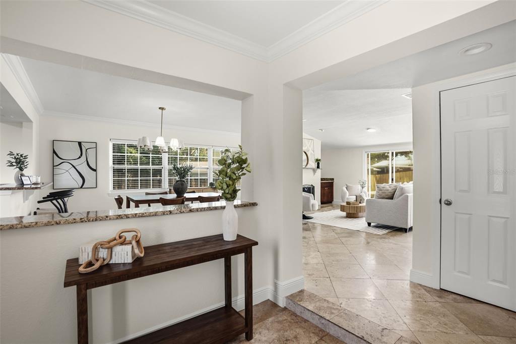 A foyer with a wooden console table leads into a living room and dining area — 2803 RIDDLE DRIVE, WINTER PARK, FL