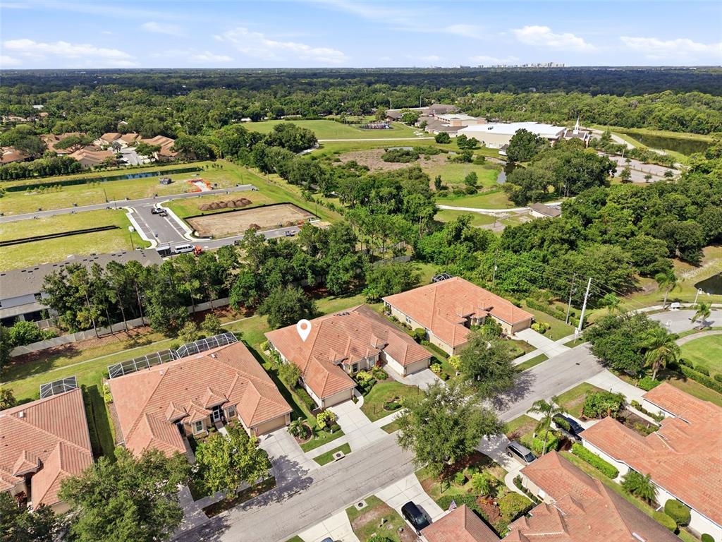 An aerial view shows a suburban neighborhood with several houses featuring terracotta-tiled roofs — 4316 CALLISTA LANE, SARASOTA, FL