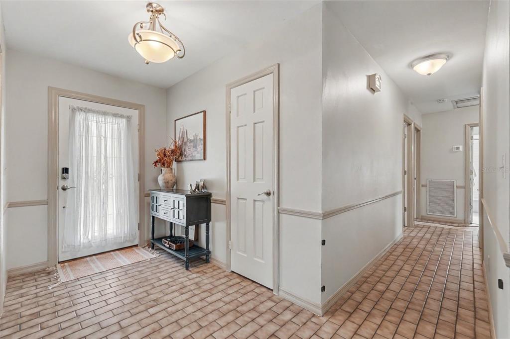 A single-story light-colored brick house with a gray roof and an attached garage — 112 W BRENTRIDGE DRIVE, BRANDON, FL