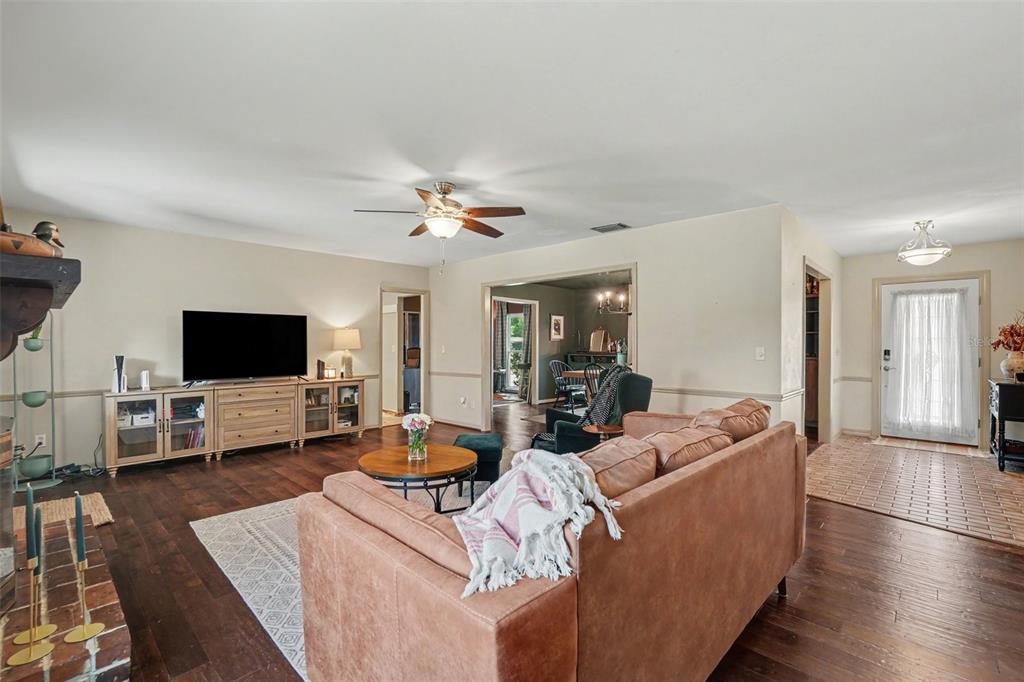 An entryway with light wood flooring, beige walls, white trim, and a white front door — 112 W BRENTRIDGE DRIVE, BRANDON, FL