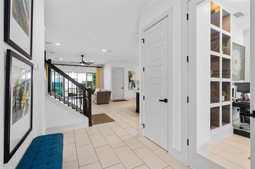 A bright hallway leads to a living area with a staircase and a glass-walled office — 344 WHEELHOUSE LANE, LAKE MARY, FL