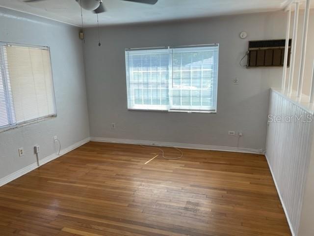 An empty room with hardwood floors, light gray walls, and a window with blinds — 888 14TH AVENUE S, ST PETERSBURG, FL