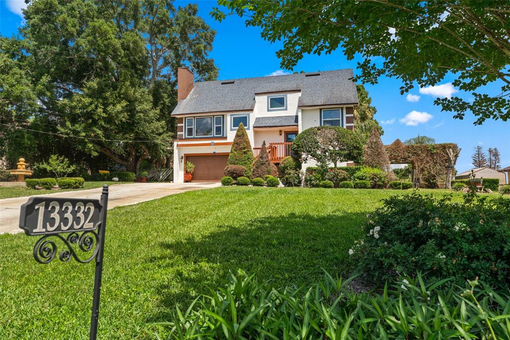 A two-story house with a brown garage, a wooden deck, and a front lawn — 13332 SUBURBAN TERRACE, WINTER GARDEN, FL