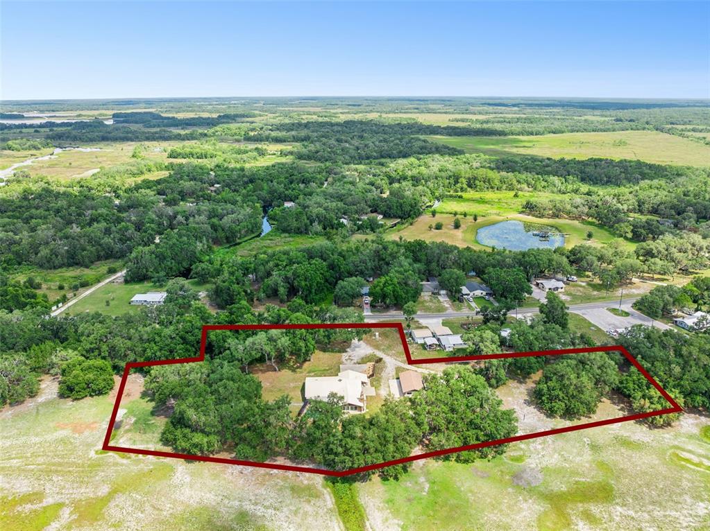 An aerial view shows a house and outbuilding on a lot outlined in red — 7232 E TURNER CAMP ROAD, INVERNESS, FL