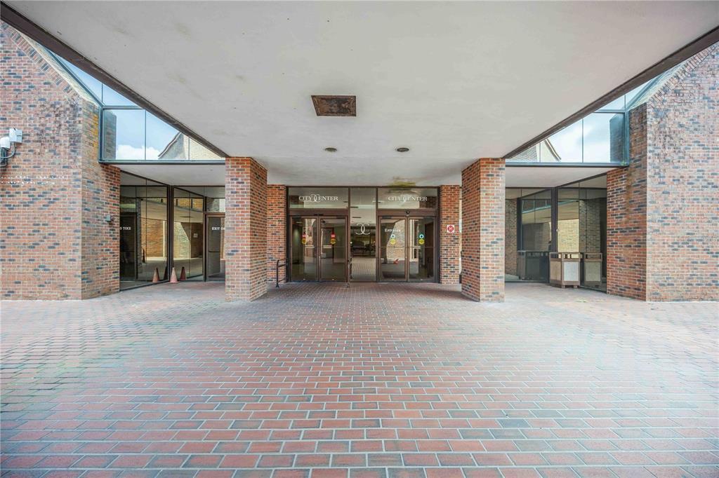 A brick-paved covered entrance leads to the glass doors of a brick commercial building — 1620 TAMIAMI TRAIL, PORT CHARLOTTE, FL