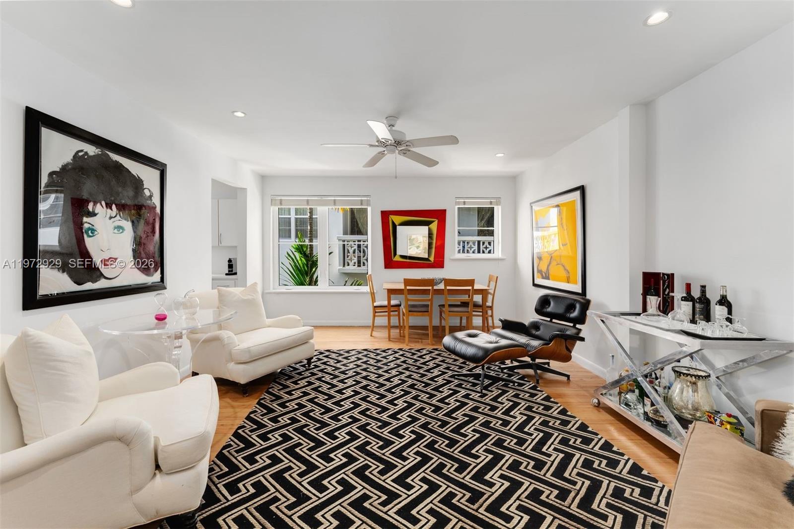A living and dining room features white walls, a geometric rug, and modern furniture — 1018 Meridian Ave # 8, Miami Beach FL 33139, MIAMI BEACH, FL