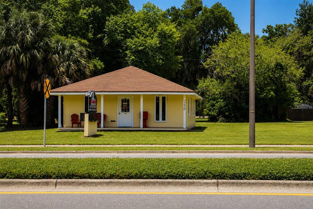 A yellow, single-story building with a brown roof sits on a grassy lot — 7230 SE US HIGHWAY 301, HAWTHORNE, FL
