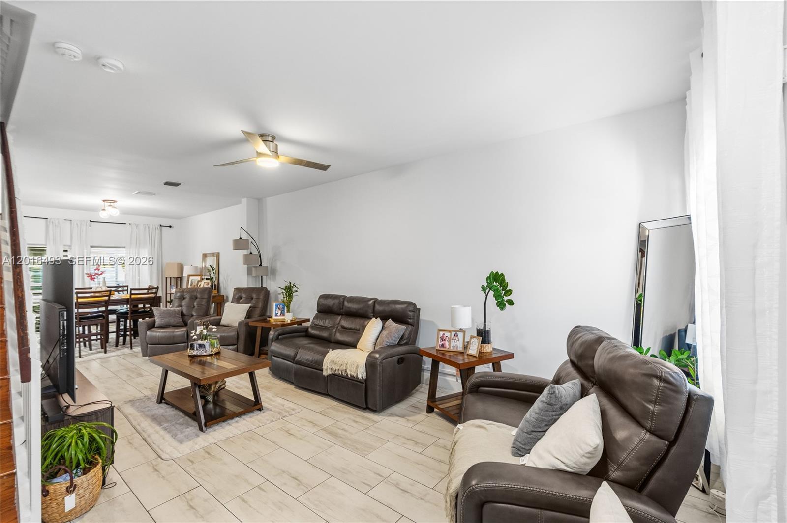 A living room features brown leather furniture, a wooden coffee table, and light tile flooring — 1844 SW 102nd Way, Miramar FL 33025, MIRAMAR, FL