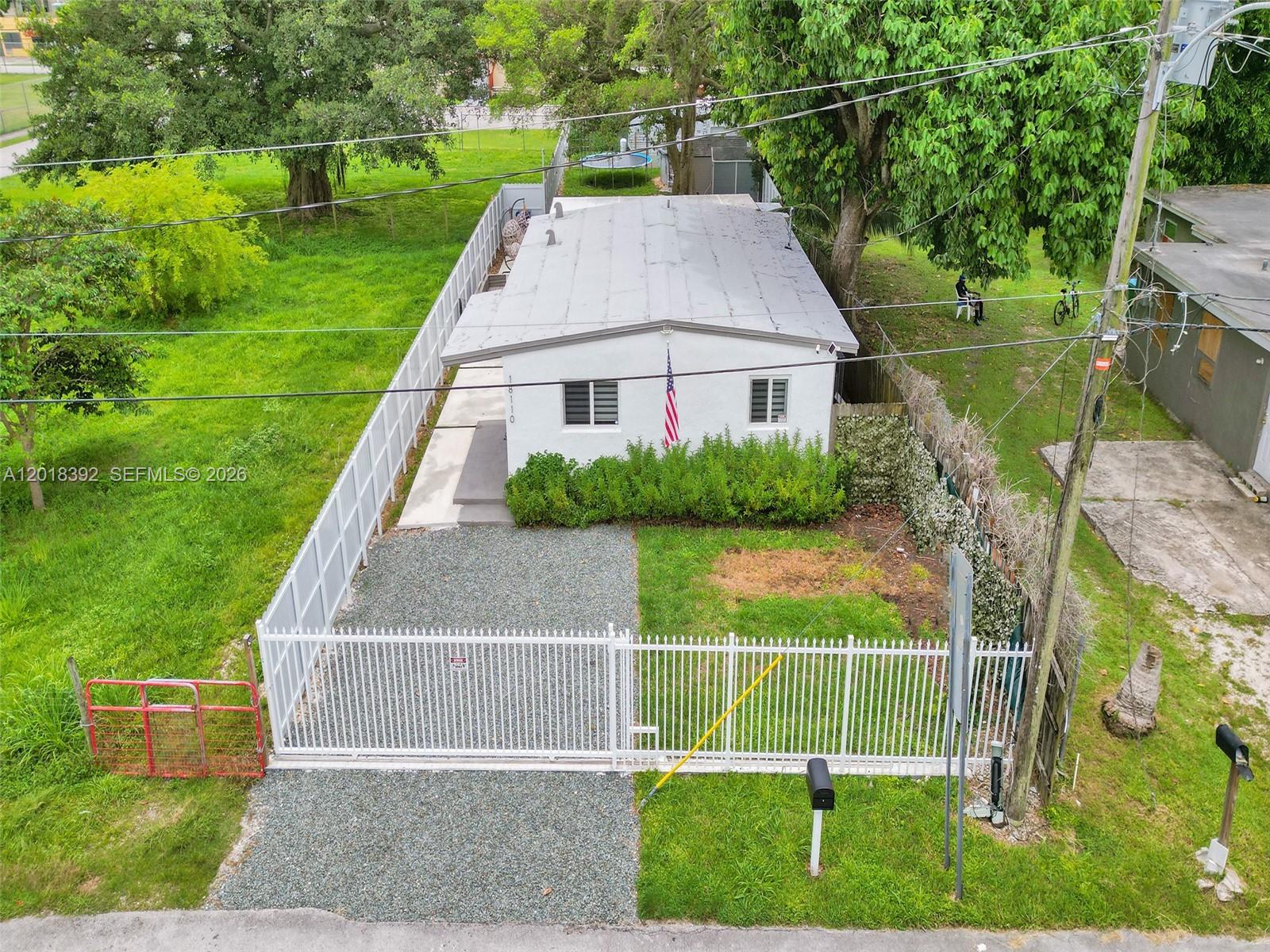 An aerial view shows a small white house with a gravel driveway and white fencing — 10222 SW 181st St, Miami FL 33157, MIAMI, FL
