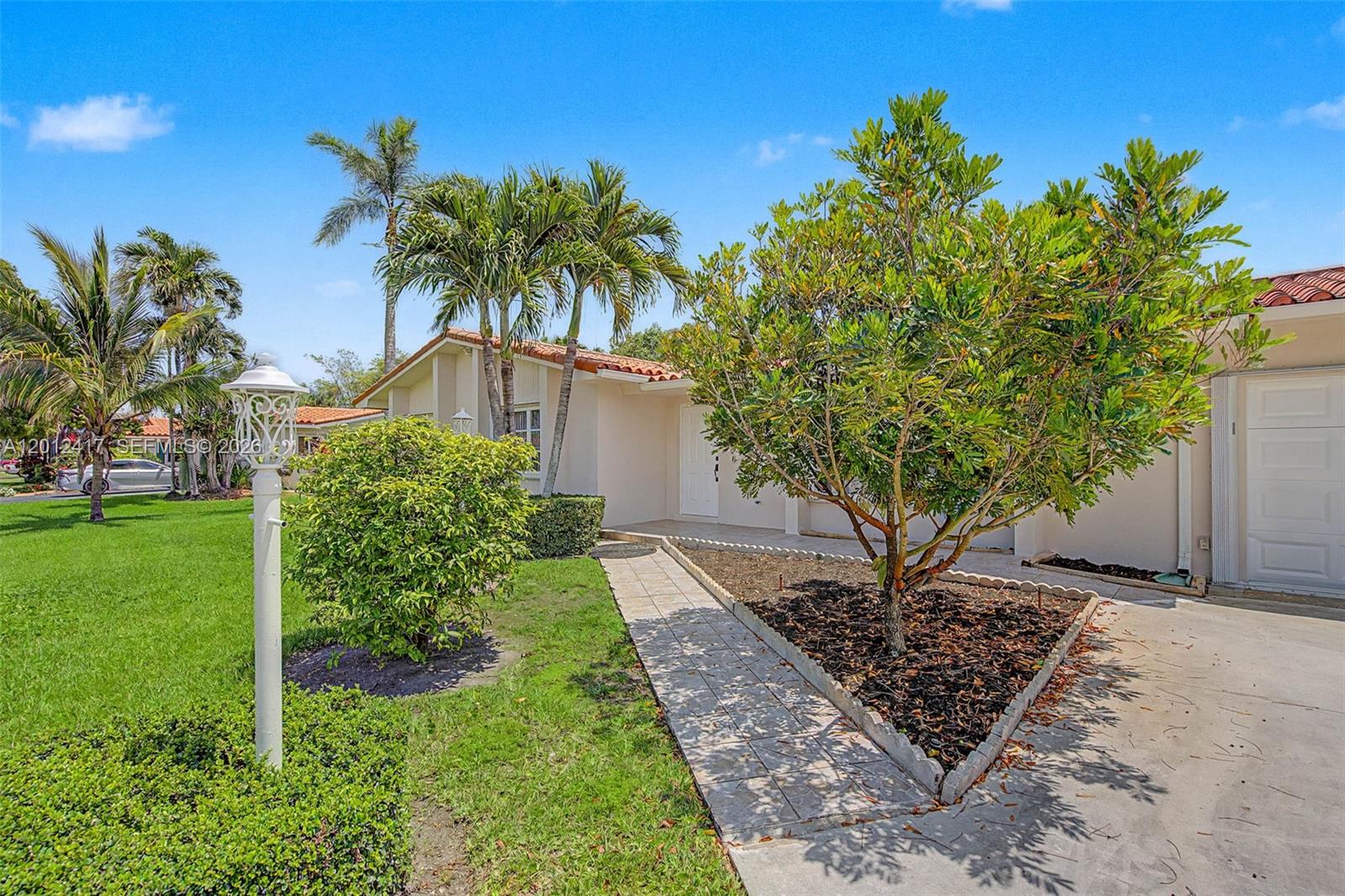 A single-story house with a tiled roof, palm trees, and a paved walkway — 11380 SW 131st St, Miami FL 33176, MIAMI, FL