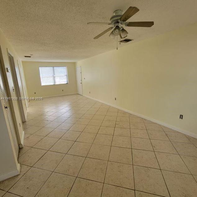 A bathroom features a white vanity, a toilet, and a bathtub with tiled walls — 814 Finley Ct, Hollywood FL 33020, HOLLYWOOD, FL