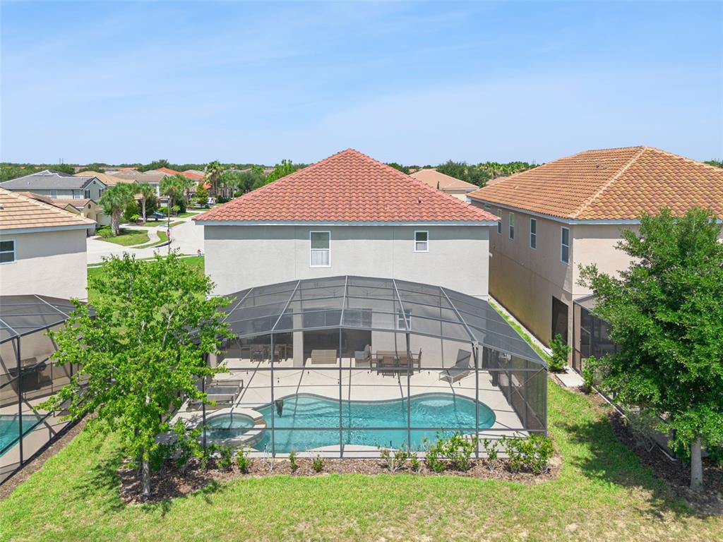 An aerial view of a two-story house with a screened-in pool and patio area — 5304 OAKBOURNE AVENUE, DAVENPORT, FL