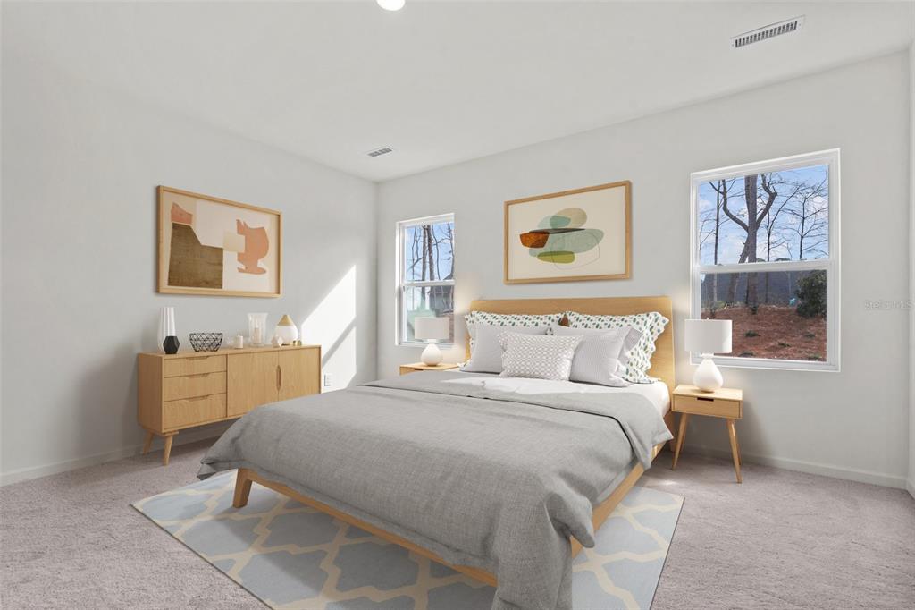 A bedroom features a bed, two nightstands, a dresser, and two windows with outdoor views — 36094 CANELLI WAY, DADE CITY, FL