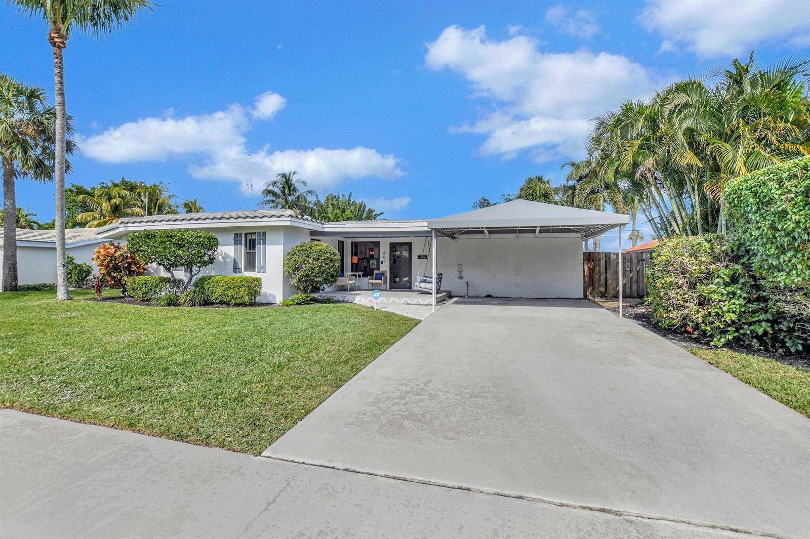 A single-story white house with a concrete driveway and a metal carport — 801 SW 5th Street, Boca Raton FL 33486, BOCA RATON, FL
