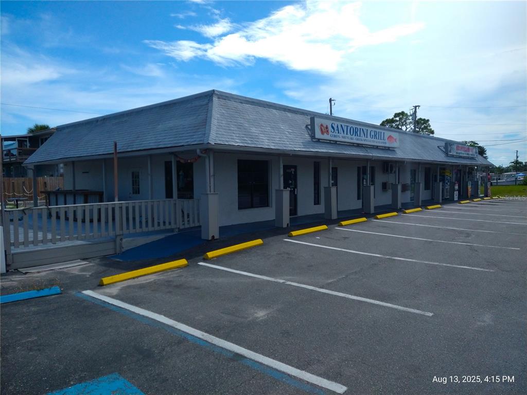 The exterior of a single-story commercial building with a parking lot and a restaurant sign — 6920,6922,6924,6926,6928 CLARK STREET, HUDSON, FL