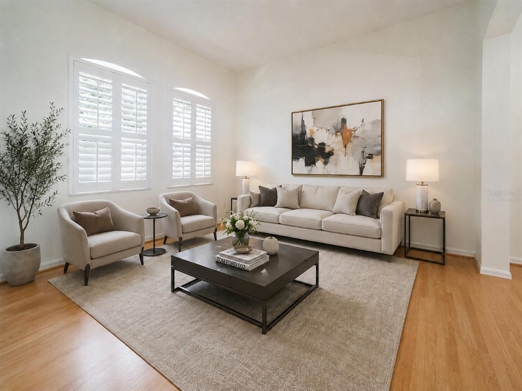 A living room features a beige sofa, two armchairs, a coffee table, and hardwood floors — 974 KERSFIELD CIRCLE, LAKE MARY, FL