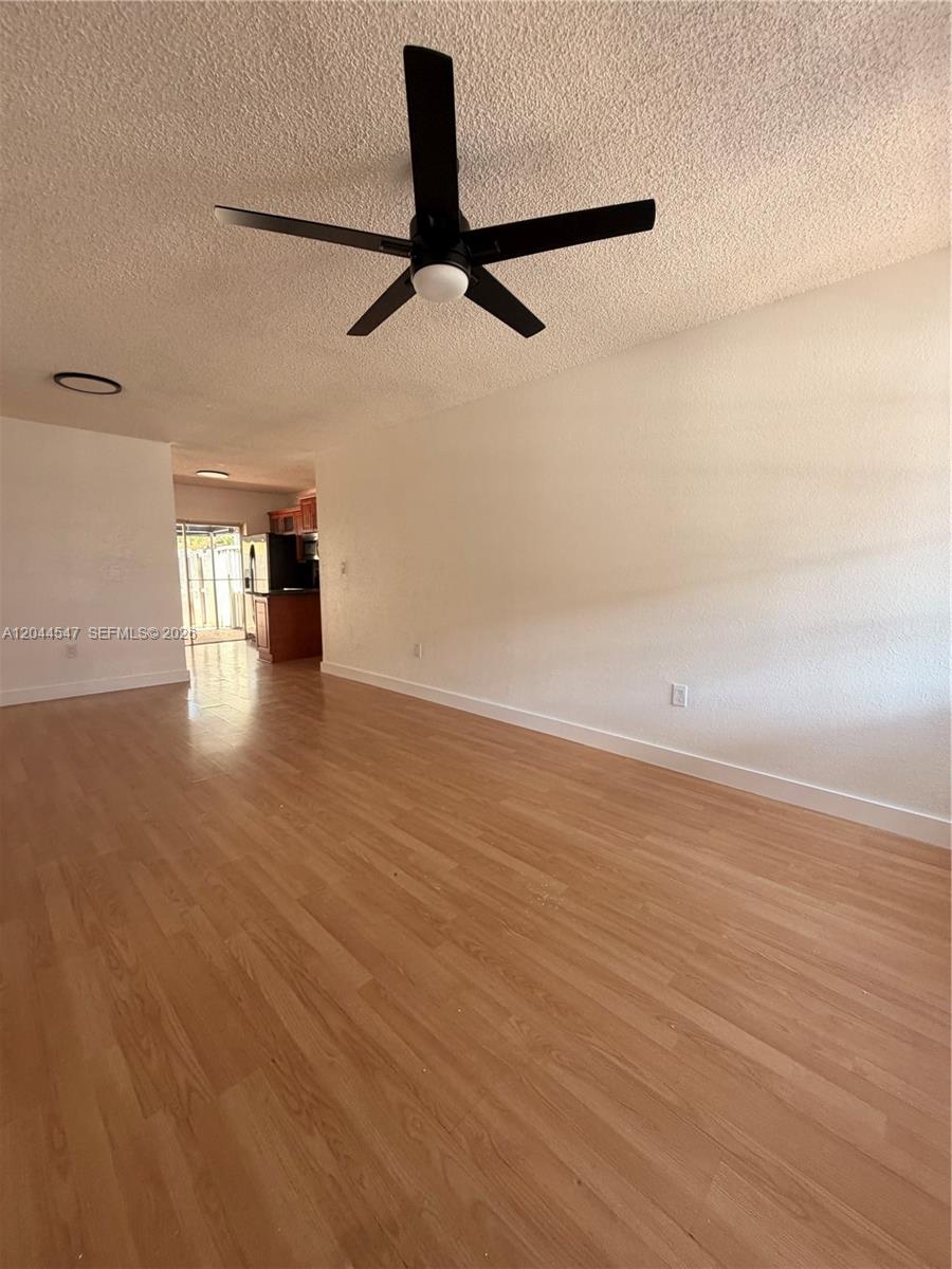 The exterior of a house features a covered porch, blue tiled arches, and flowering bushes — 7000 NW 173rd Dr # 1805, Hialeah FL 33015, HIALEAH, FL