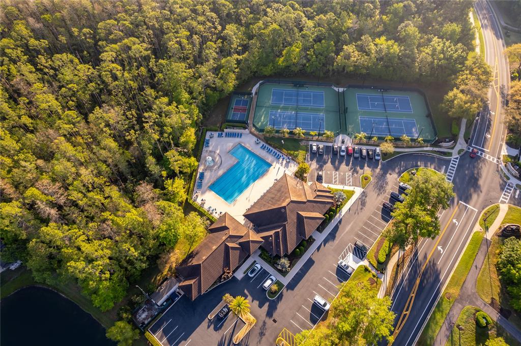 An aerial view shows a community clubhouse with a pool, tennis courts, and parking lot — 2591 DOVER GLEN CIRCLE, ORLANDO, FL
