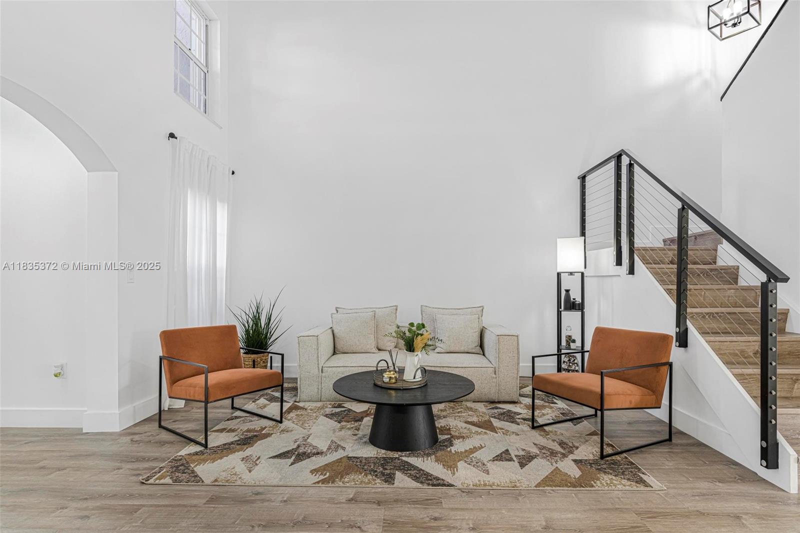 A living room features a sofa, two orange chairs, a coffee table, and a staircase — 11532 SW 148th Path, Miami FL 33196, MIAMI, FL