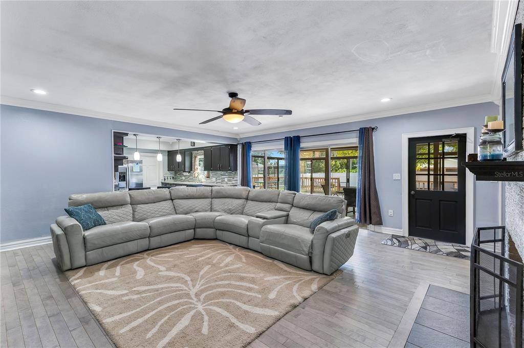 A two-story brick house features a second-floor balcony, arched windows, and a detached metal garage — 811 FAIRLINGTON DRIVE, LAKELAND, FL