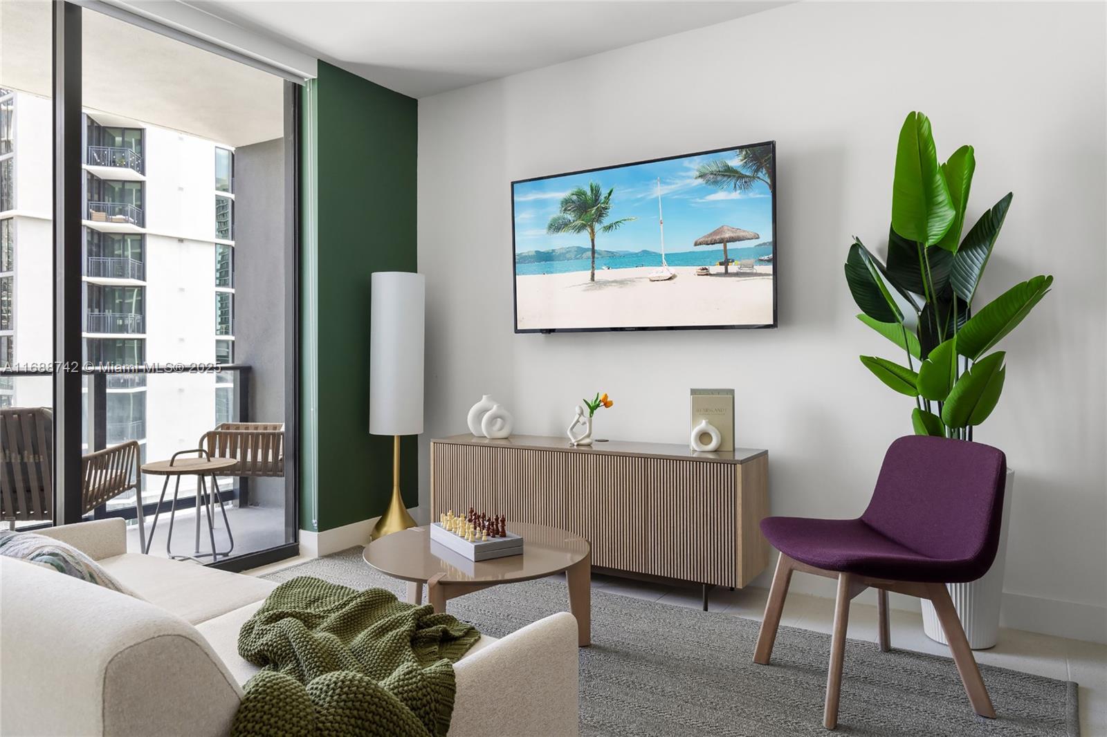 A living room features a wall-mounted television, a wooden media console, and a purple chair — 159 NE 6TH ST # 3013, Miami FL 33132, MIAMI, FL