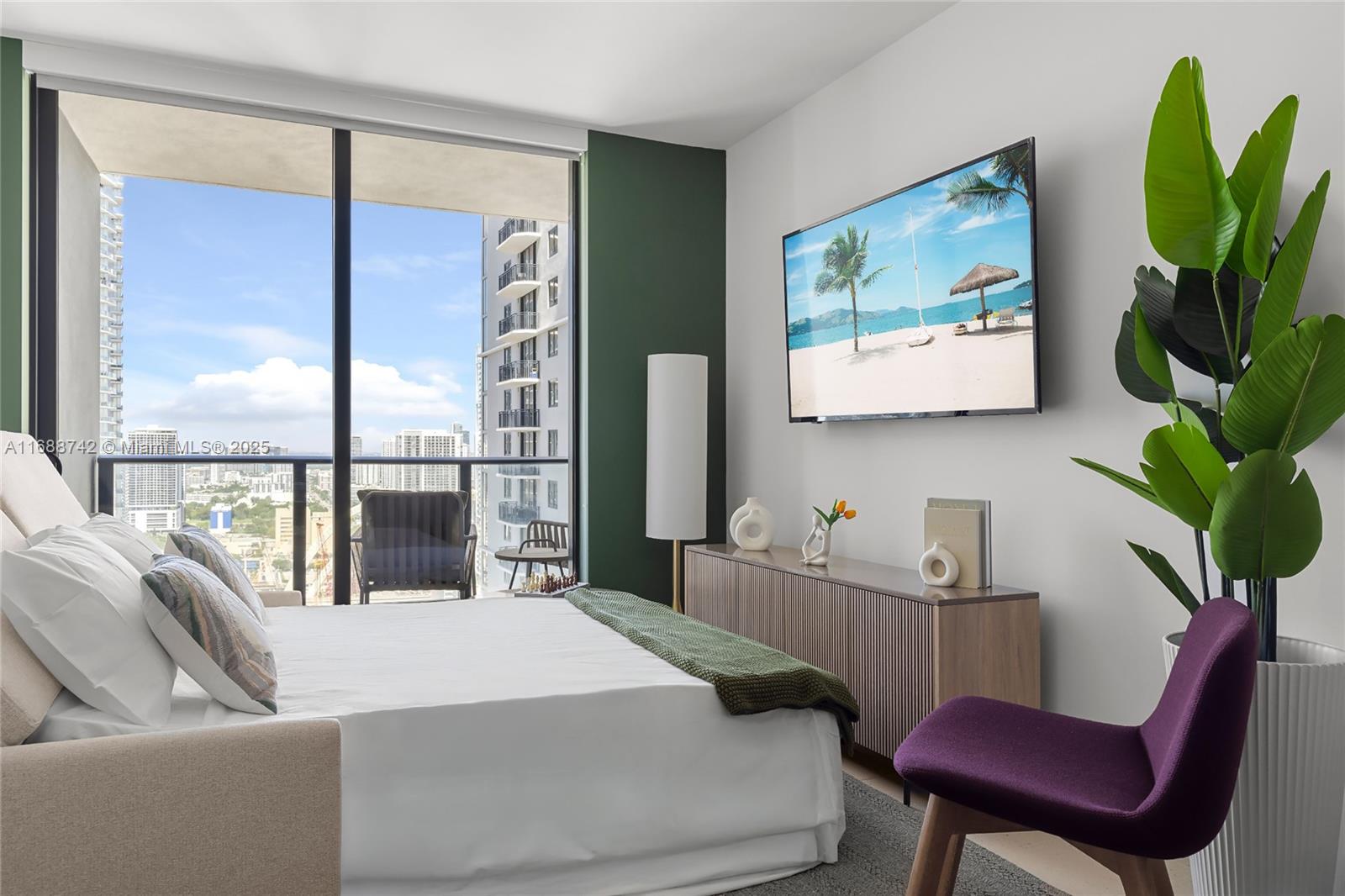 A bedroom features a bed, a wall-mounted television, a wooden console, and a large window — 159 NE 6TH ST # 3013, Miami FL 33132, MIAMI, FL