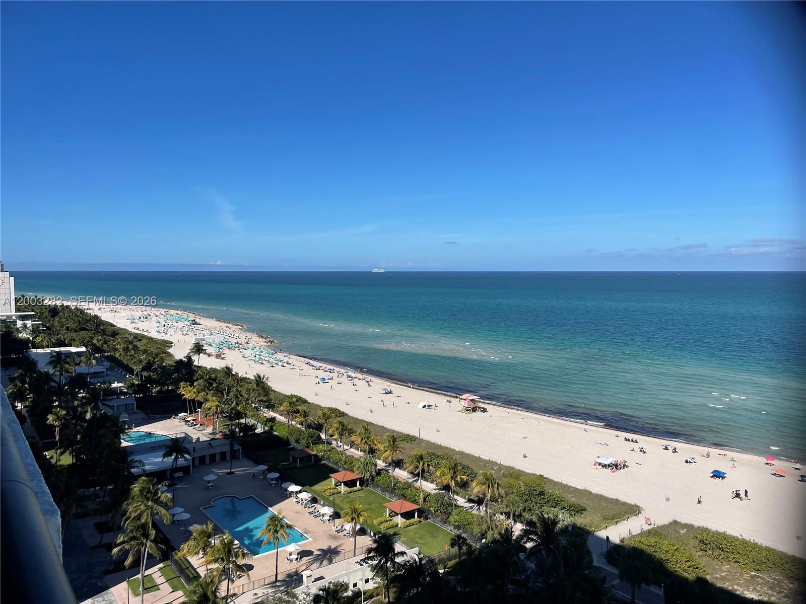 An elevated view of a sandy beach, ocean, and swimming pool area — 2555 Collins Ave # 1805, Miami Beach FL 33140, MIAMI BEACH, FL