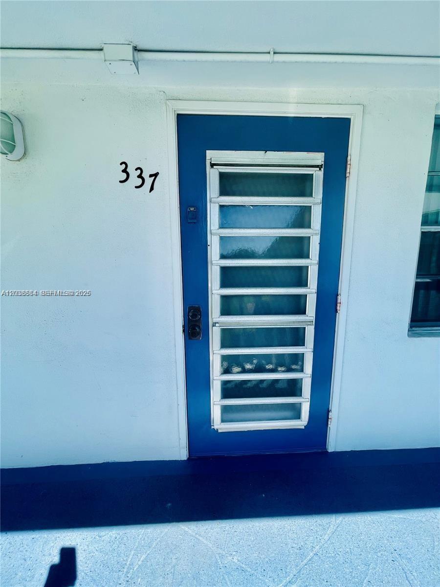 A blue door with a louvered security gate is marked with the number 337 — 337 Durham J # 337, Deerfield Beach FL 33442, DEERFIELD BEACH, FL