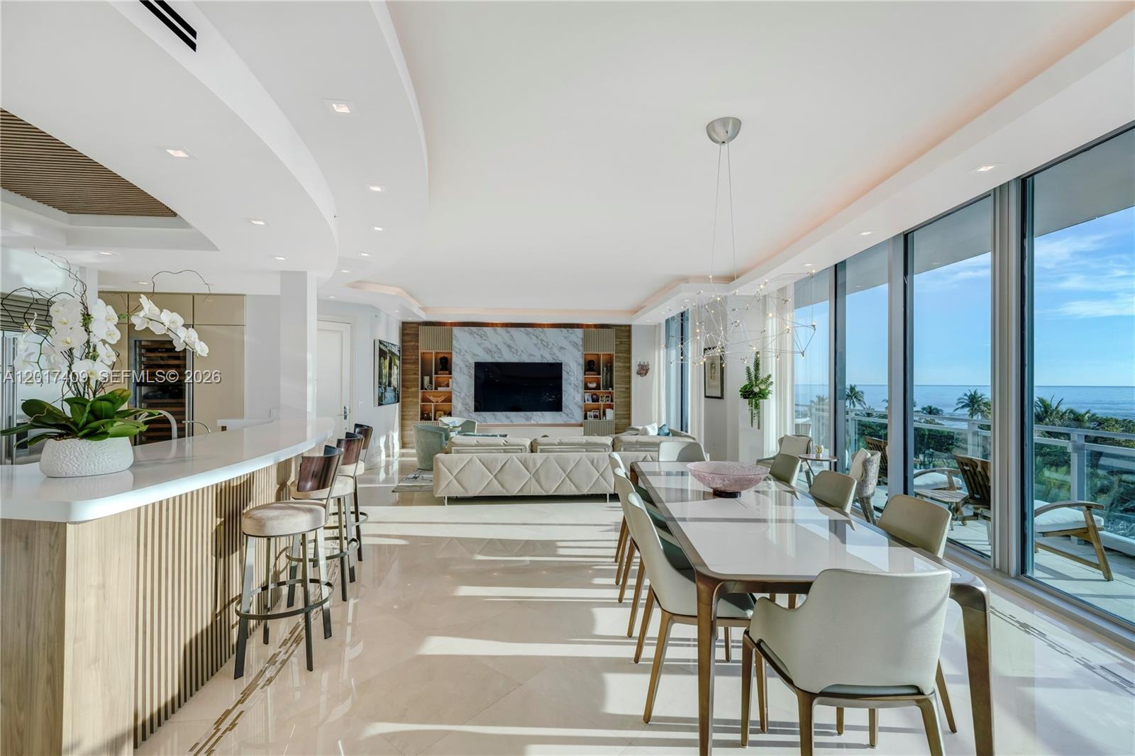 A modern open-concept living and dining area features marble floors, floor-to-ceiling windows, and ocean views — 10295 Collins Ave # 301, Bal Harbour FL 33154, BAL HARBOUR, FL