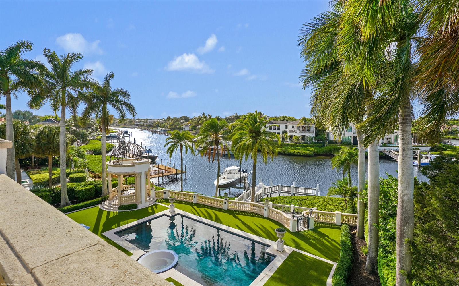 An elevated view of a swimming pool, gazebo, and boat dock along a canal — 370 Eagle Drive, Jupiter FL 33477, JUPITER, FL