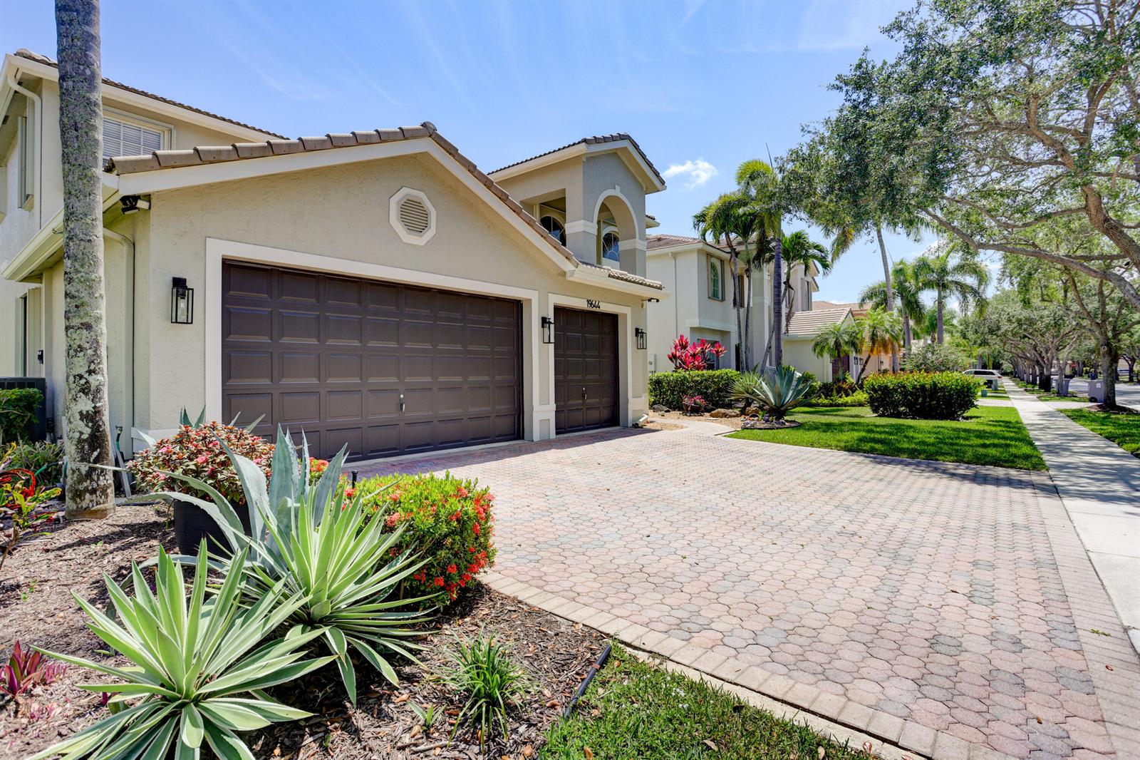A beige two-story house with a three-car garage and a paved driveway — 19644 Estuary Drive, Boca Raton FL 33498, BOCA RATON, FL