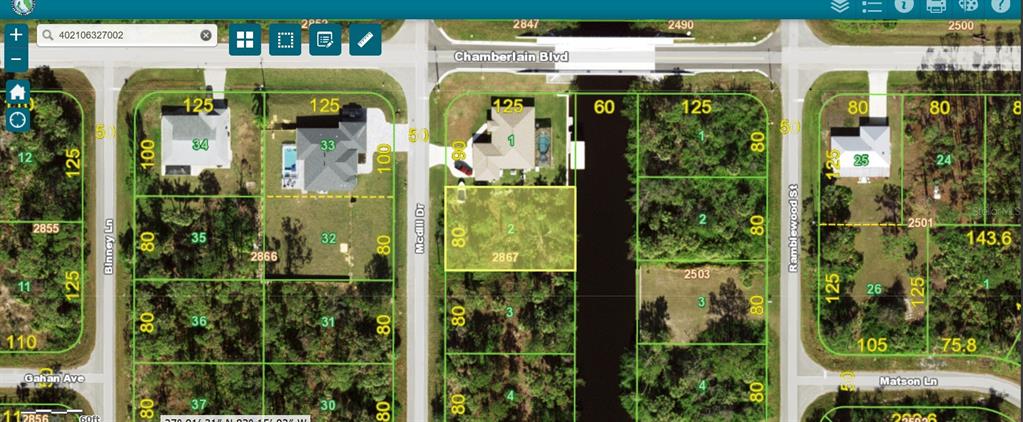 This is a satellite map view showing residential lots and a canal in a neighborhood — 306 MCDILL DRIVE, PORT CHARLOTTE, FL