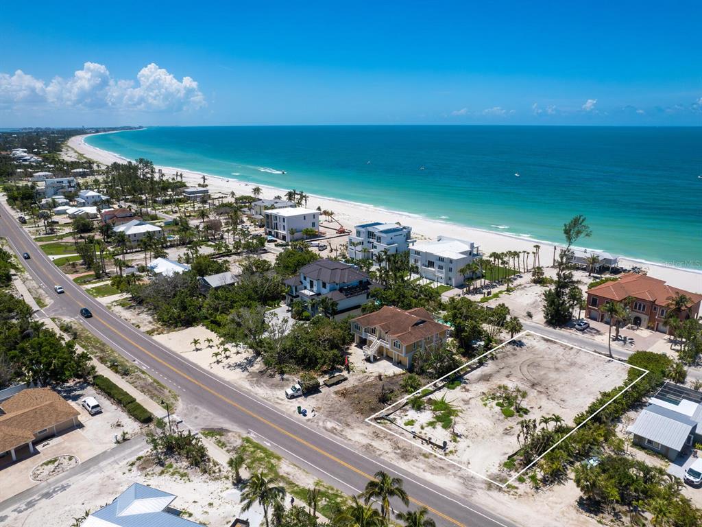 An aerial view shows a vacant, rectangular beachside lot outlined in white near the ocean — 6549 GULF OF MEXICO DRIVE, LONGBOAT KEY, FL