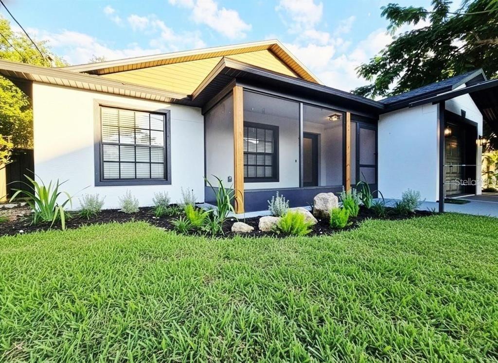 A white house with a screened-in front porch, dark trim, and landscaped front yard — 531 1ST AVENUE, ALTAMONTE SPRINGS, FL