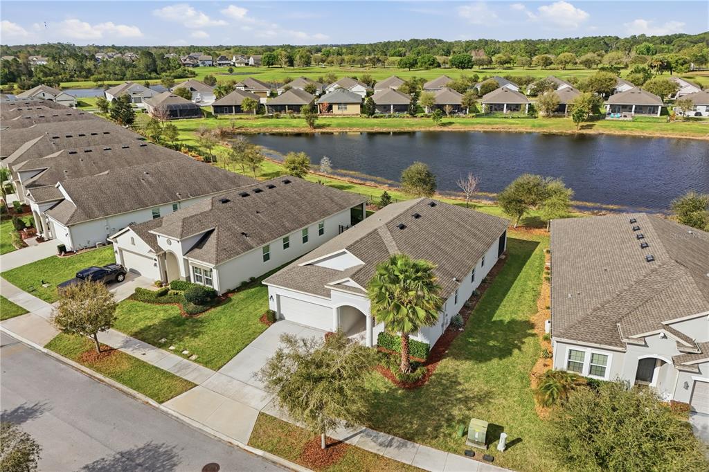 An aerial view of a single-story suburban house with a two-car garage and palm tree — 3383 SAGEBRUSH STREET, HARMONY, FL