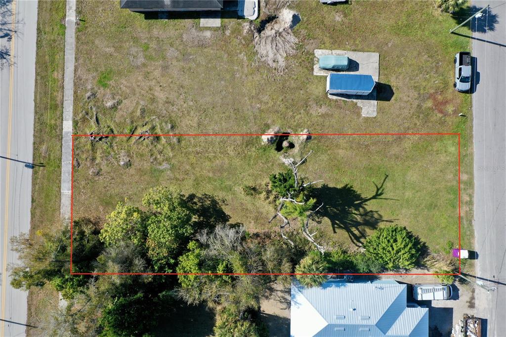 An aerial view shows a rectangular vacant lot bordered by roads and neighboring properties — 623 FITZHUGH AVENUE, PUNTA GORDA, FL